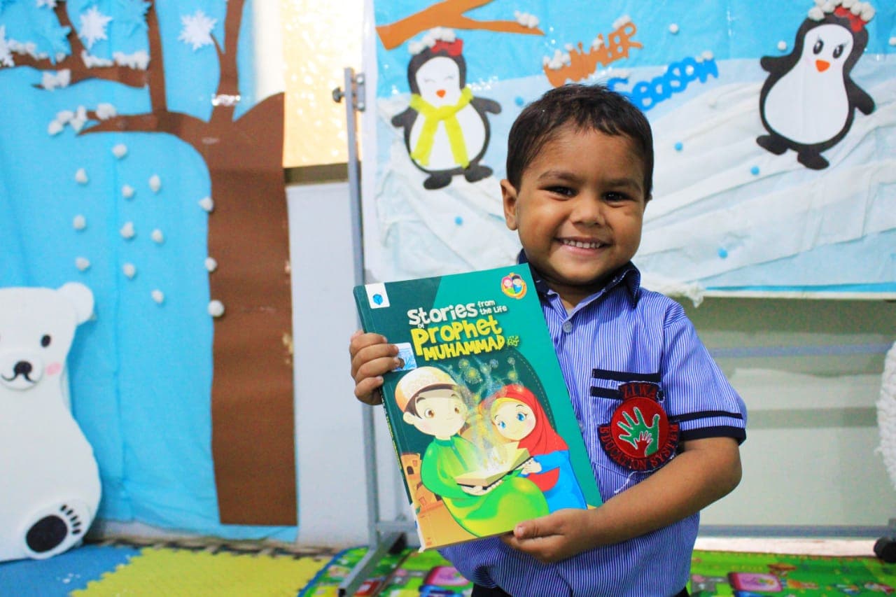 Ziwa Foundation student smiling with a book